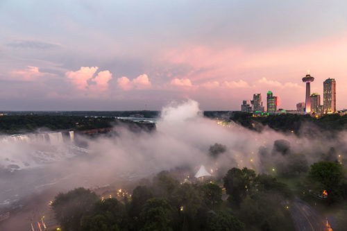 Panorama of Niagara Falls at Twilight, Canada / United States. View from the Canadian side, on left: the American Falls, in the center: the Canadian Falls (a.k.a. Horseshoe Falls), on the right: the skyline of the town Niagara Falls, Ontario.