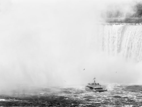 Niagara Falls, Canada / USA - A Boat with Tourists Approaches the Mist Created by the Canadian Falls